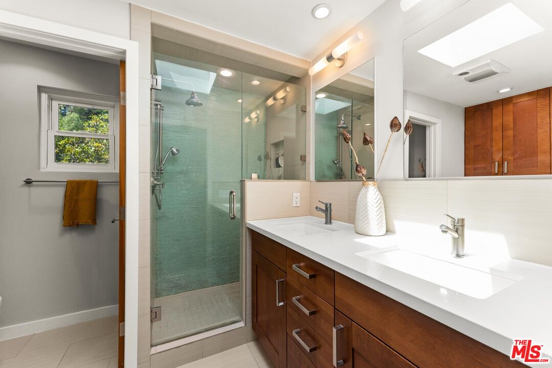 8326 Ridpath Drive Los Angeles, CA 90046 - Photo 11 of 25 a bathroom with a shower sink and mirror