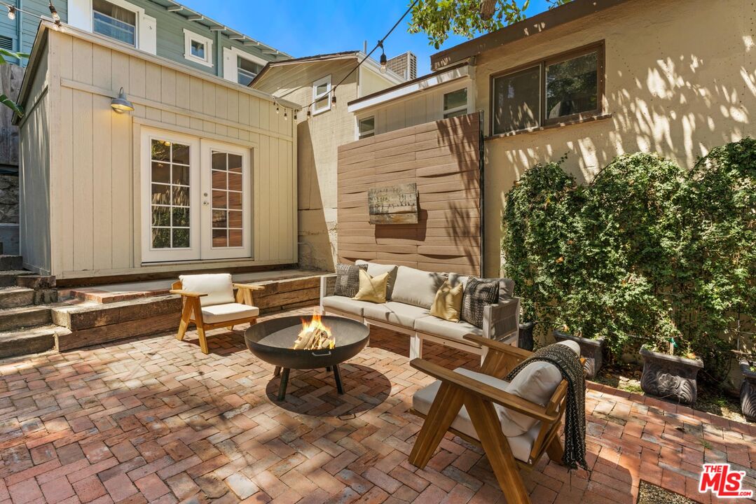 8326 Ridpath Drive Los Angeles, CA 90046 - Photo 19 of 25 a view of a chairs and table in the back yard of the house