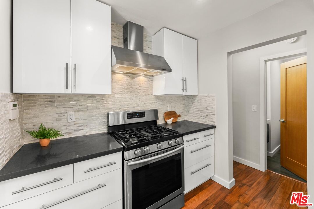 8326 Ridpath Drive Los Angeles, CA 90046 - Photo 8 of 25 a kitchen with stainless steel appliances granite countertop a sink stove and cabinets