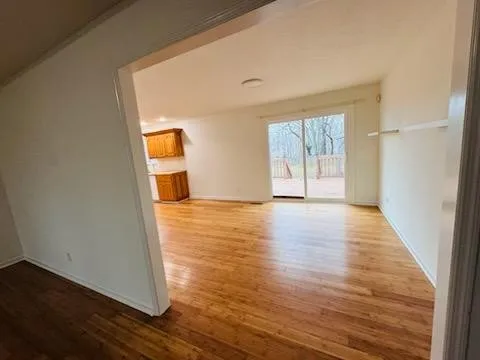 a view of a room with wooden floor and gate