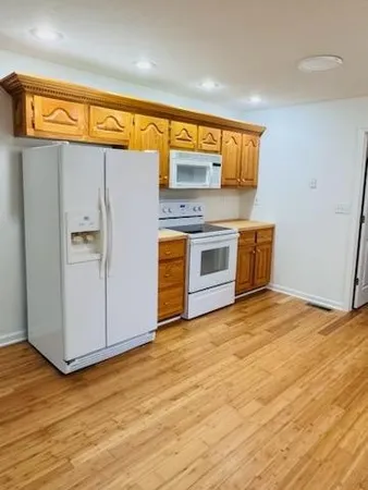 a view of a kitchen with a sink and a refrigerator
