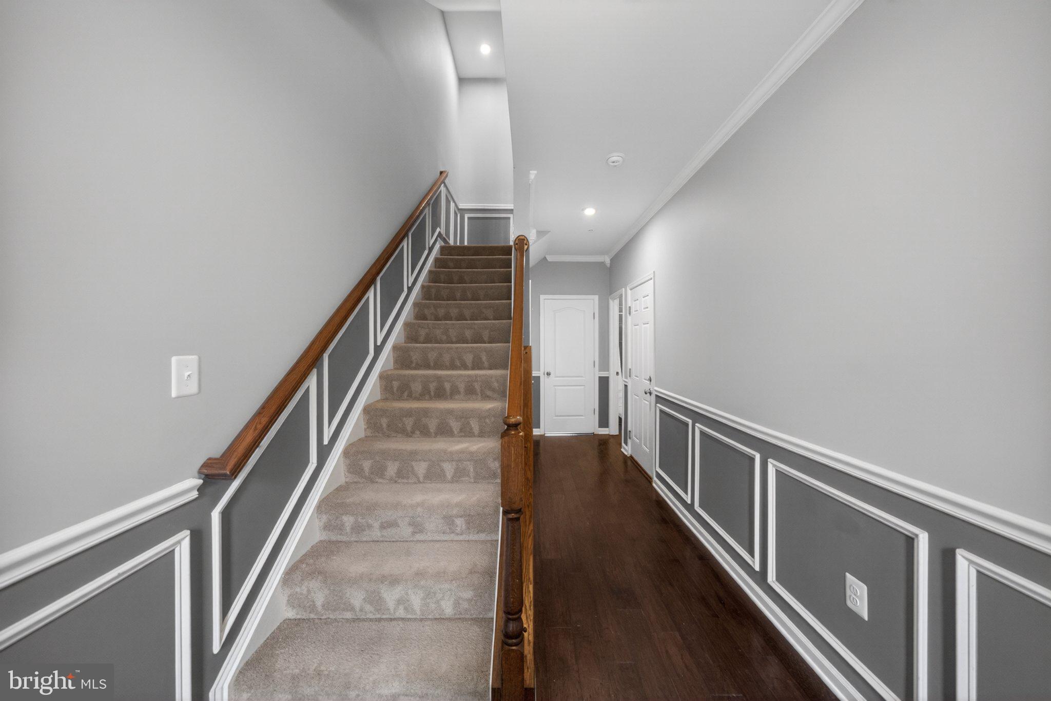 8475 Randell Ridge Road Frederick, MD 21704 - Photo 5 of 36 Elegant staircase in a modern hallway.