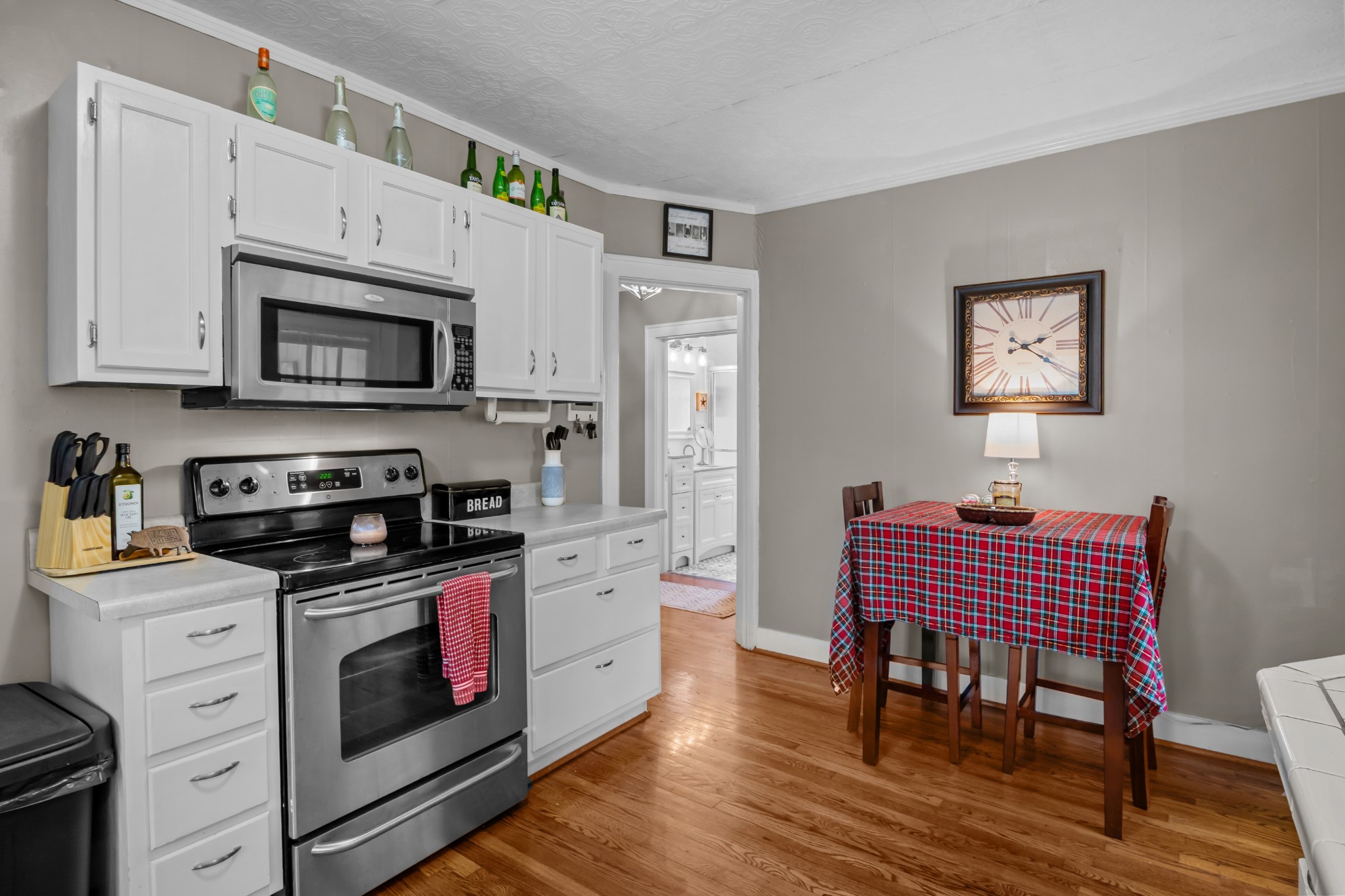 412 High Street Dickson, TN 37055 - Photo 15 of 42 a kitchen with stainless steel appliances a stove a sink cabinets and a wooden floor