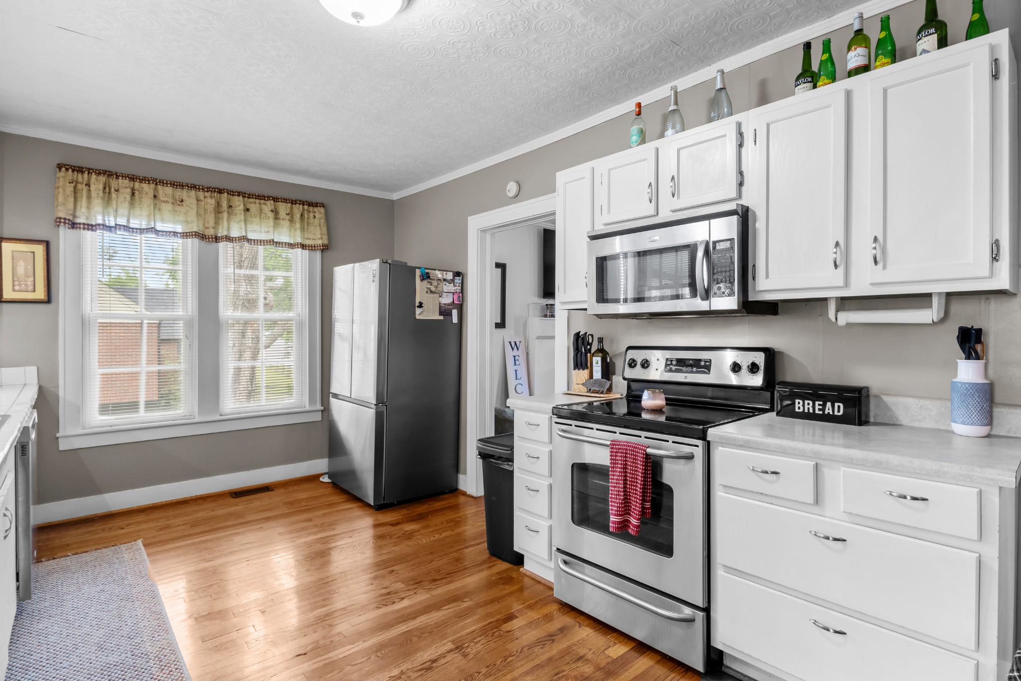 412 High Street Dickson, TN 37055 - Photo 16 of 42 a kitchen with stainless steel appliances granite countertop a refrigerator a stove a sink and white cabinets with wooden floor