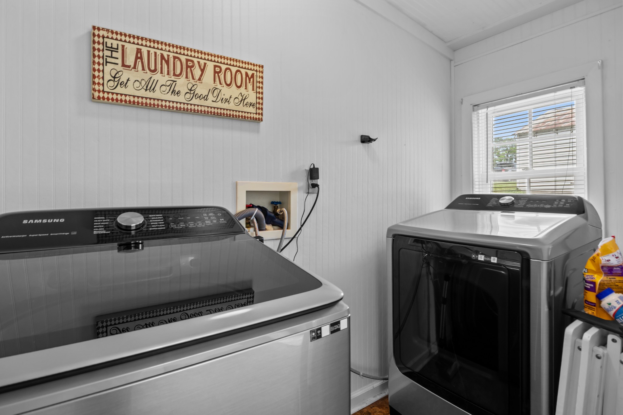 412 High Street Dickson, TN 37055 - Photo 24 of 42 a close view of sink and washing machine with white cabinet