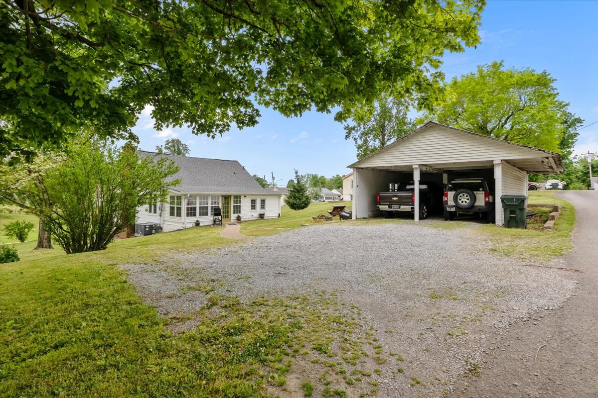 412 High Street Dickson, TN 37055 - Photo 3 of 42 a front view of a house with a yard and garage