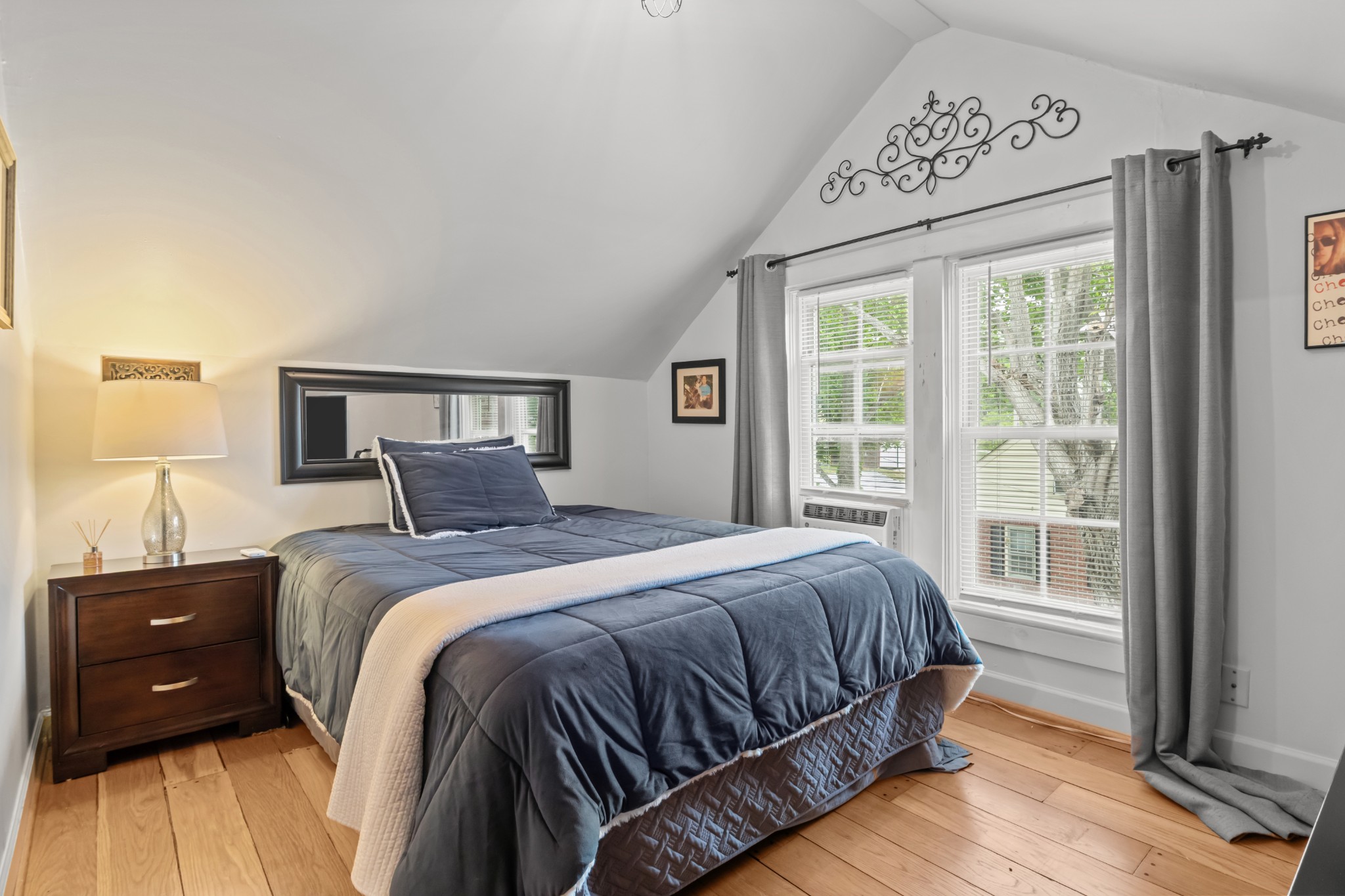 412 High Street Dickson, TN 37055 - Photo 31 of 42 a bedroom with a bed a lamp and a window