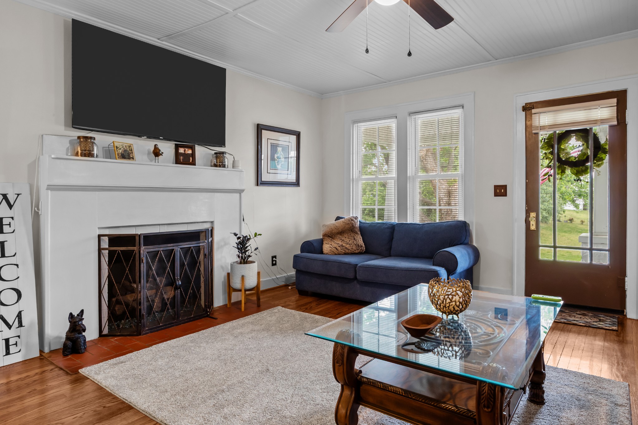 412 High Street Dickson, TN 37055 - Photo 10 of 42 a living room with furniture a flat screen tv and a fireplace