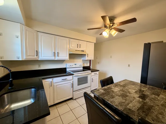 a kitchen with a stove and a refrigerator
