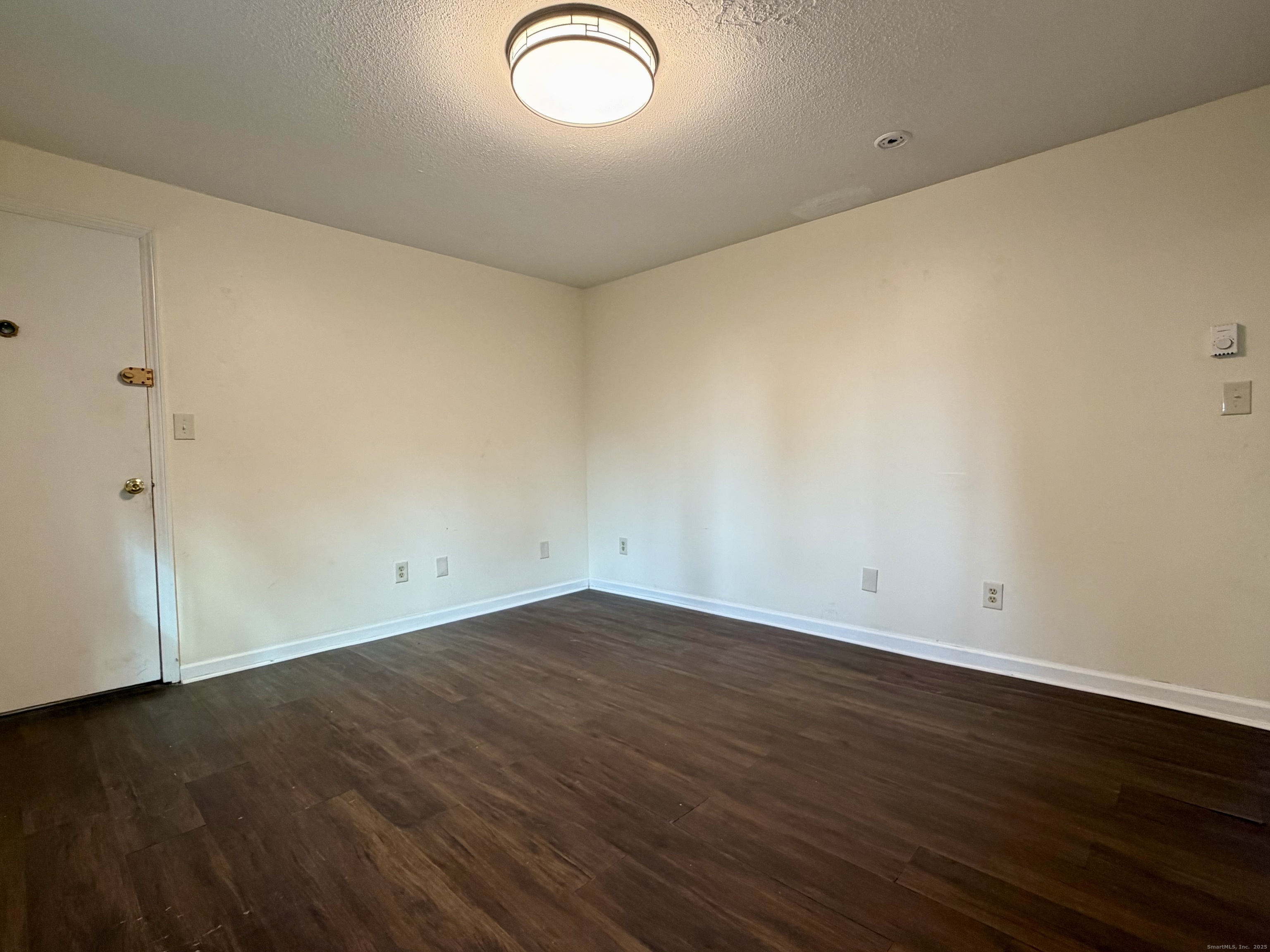 21 Weybosset Street, Unit 3 New Haven, CT 06513 - Photo 4 of 11 an empty room with wooden floor and windows