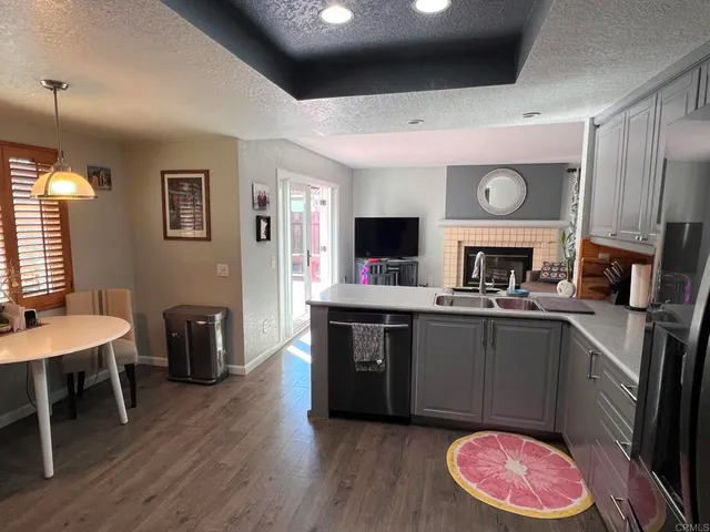a kitchen with a sink cabinets and wooden floor