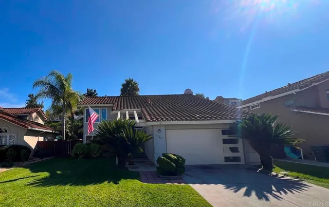 a view of a house with a yard and a garden