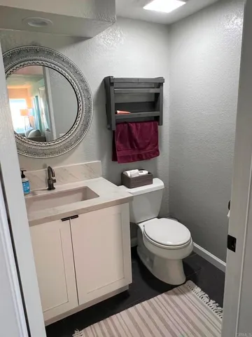 a bathroom with a toilet a sink and a mirror