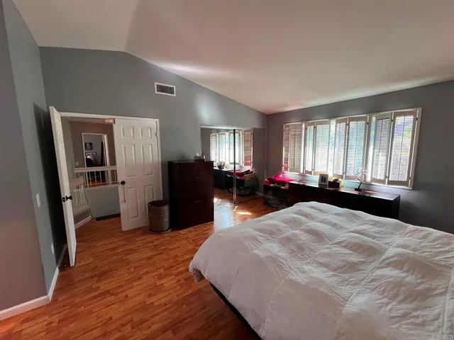 a bed room with a bed and a large mirror