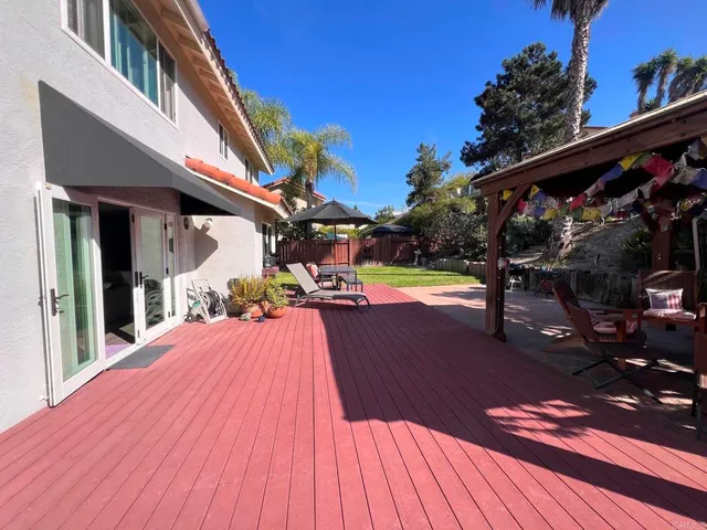 a view of a house with pool and sitting area