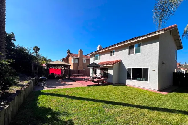 a swimming pool with outdoor seating and yard