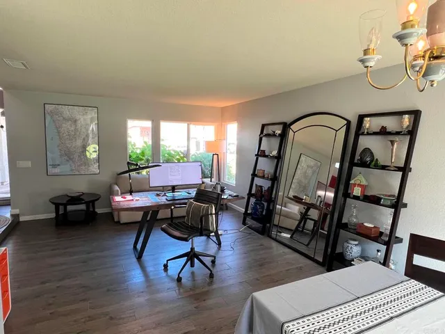 a living room with furniture a rug and a window