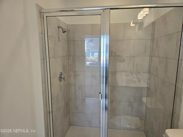 a bathroom with a glass shower door
