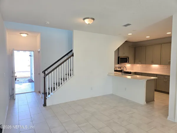 a kitchen with stainless steel appliances granite countertop a refrigerator and a stove top oven
