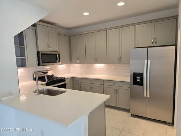 a kitchen with a refrigerator sink and microwave