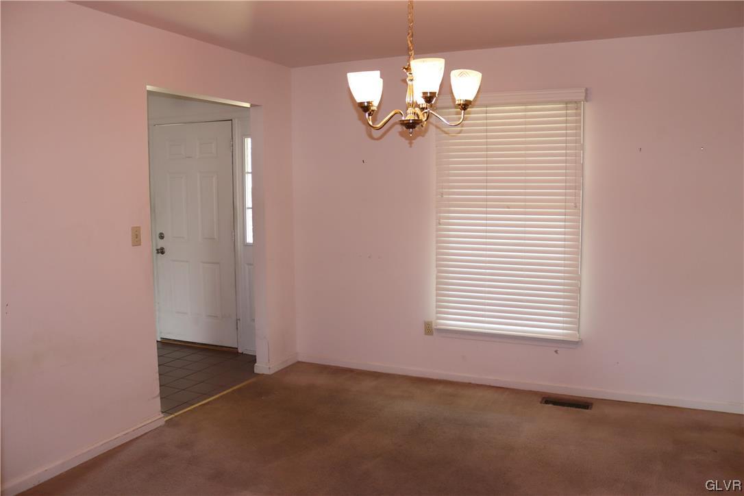 4190 Alder Road Bethlehem, PA 18020 - Photo 10 of 27 en empty room with windows and a chandelier