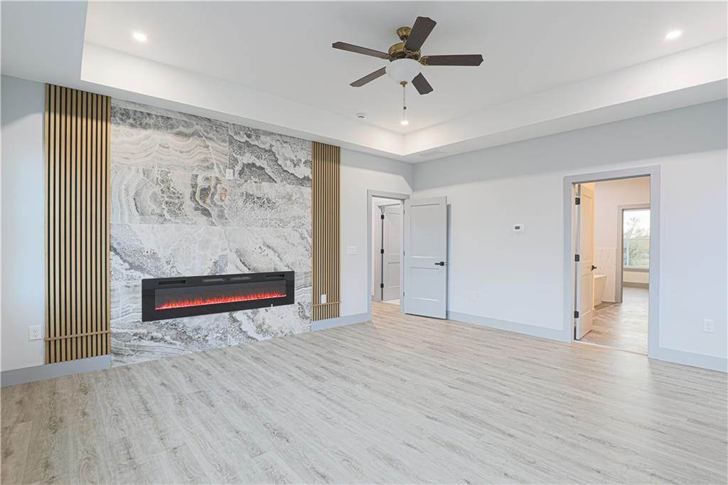 1341 Wheeler Creek Road Maysville, GA 30558 - Photo 3 of 51 an empty room with wooden floor and a ceiling fan