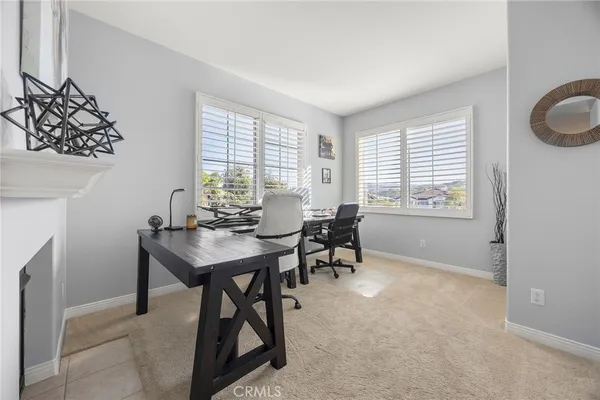 a view of a dining room with furniture and a window