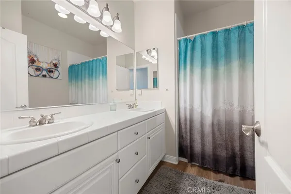a bathroom with a double vanity sink and a mirror