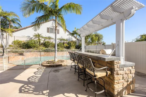a view of a patio with a table chairs and swimming pool