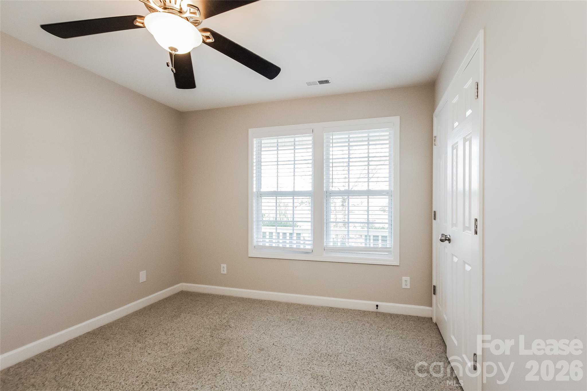 11647 Tucker Field Road Midland, NC 28107 - Photo 11 of 15 an empty room with windows and fan