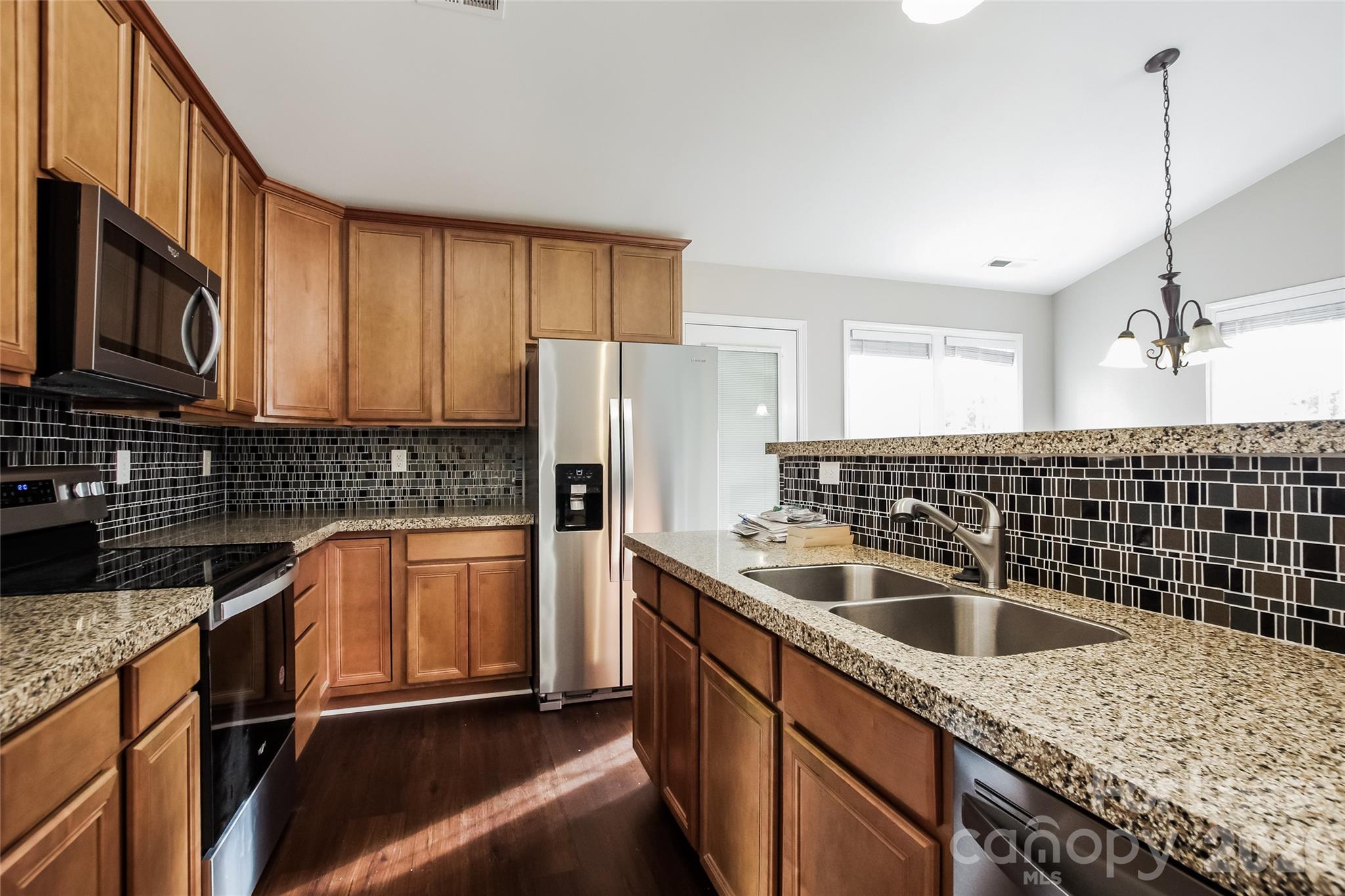 11647 Tucker Field Road Midland, NC 28107 - Photo 2 of 15 a kitchen with stainless steel appliances granite countertop a sink stove and refrigerator