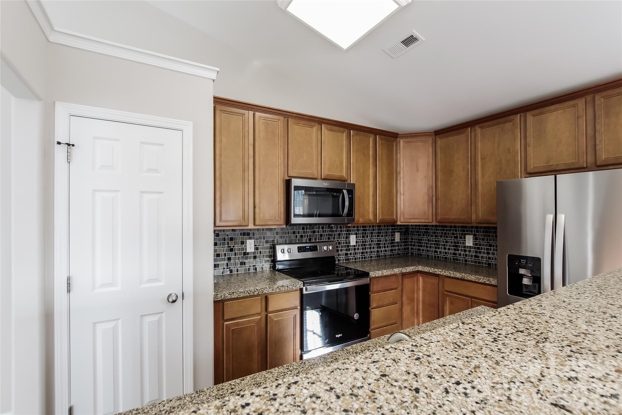 11647 Tucker Field Road Midland, NC 28107 - Photo 4 of 15 a kitchen with a refrigerator stove and sink