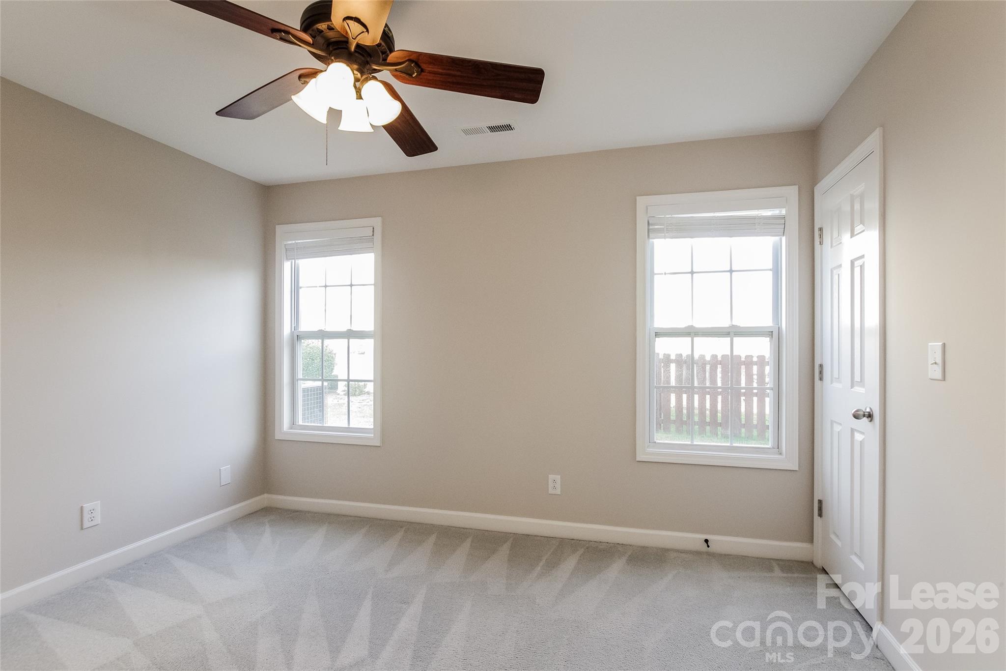 11647 Tucker Field Road Midland, NC 28107 - Photo 9 of 15 an empty room with windows and fan