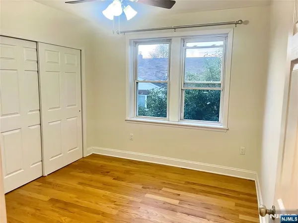 a view of a room with wooden floor and natural light