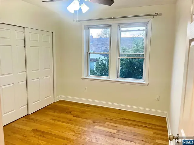a view of a room with wooden floor and natural light