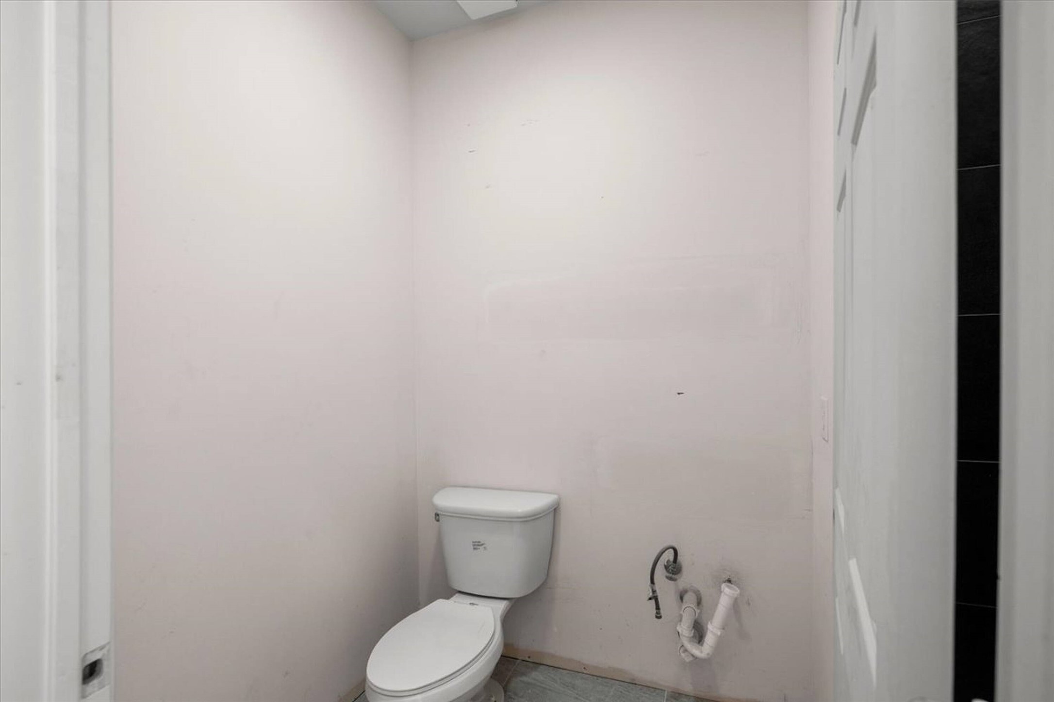 375 King Rea Spur Georgetown, TX 78633 - Photo 5 of 29 White ceramic toilet with visible plumbing rough-ins