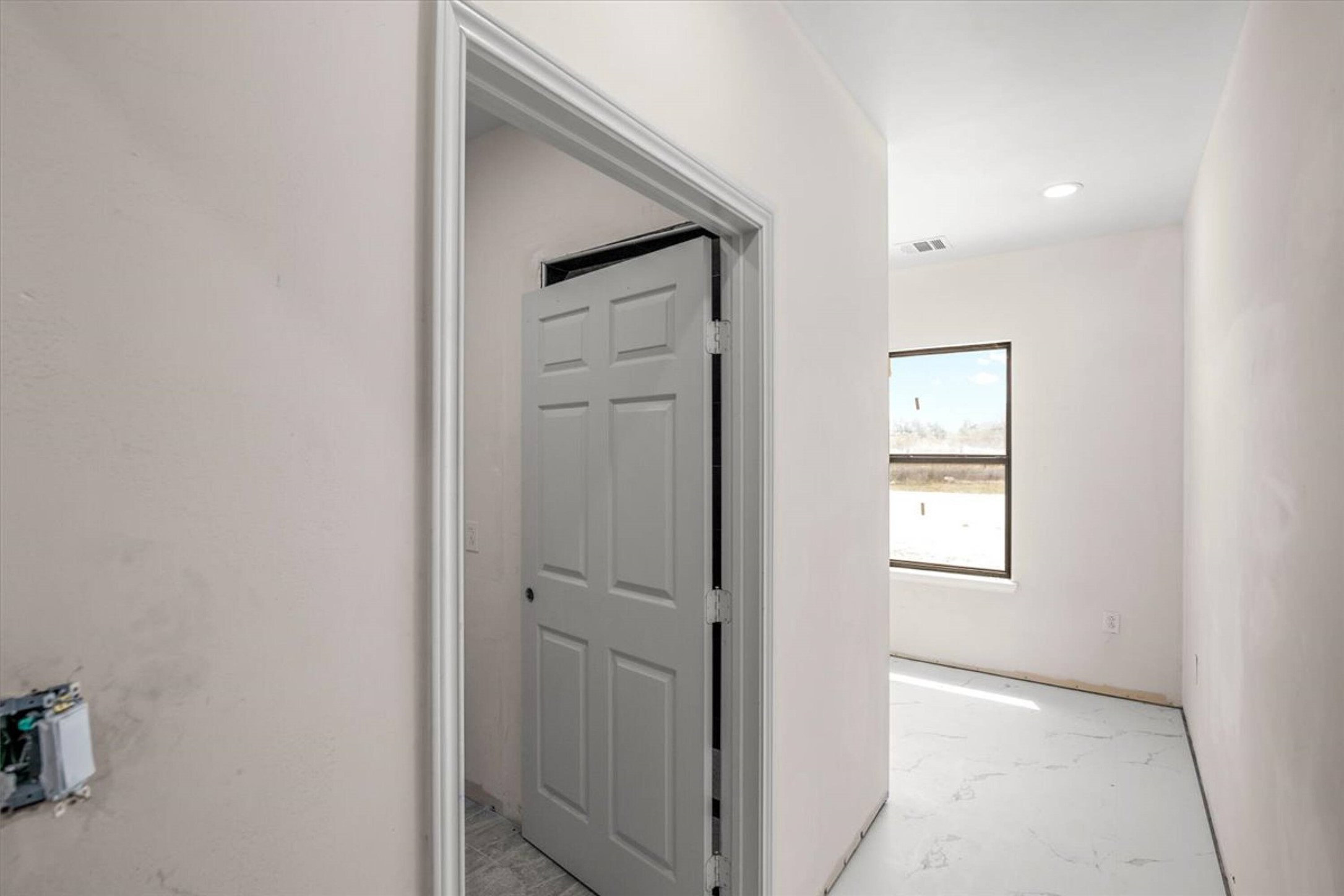 375 King Rea Spur Georgetown, TX 78633 - Photo 6 of 29 Hallway featuring light-toned walls, recessed lighting, baseboard trim, and a window with dark framing