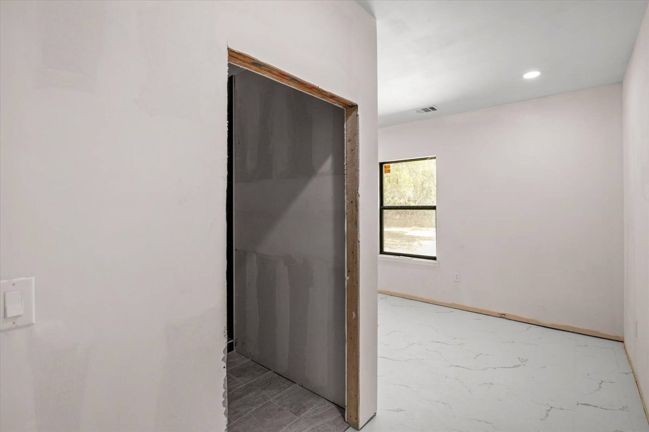 375 King Rea Spur Georgetown, TX 78633 - Photo 9 of 29 Unfinished interior space featuring a window with black trim, recessed lighting, and light-toned flooring