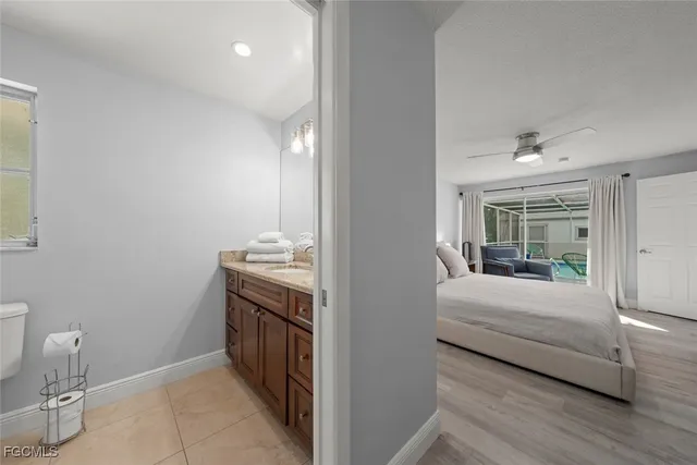 a bathroom with a granite countertop toilet a sink and a mirror