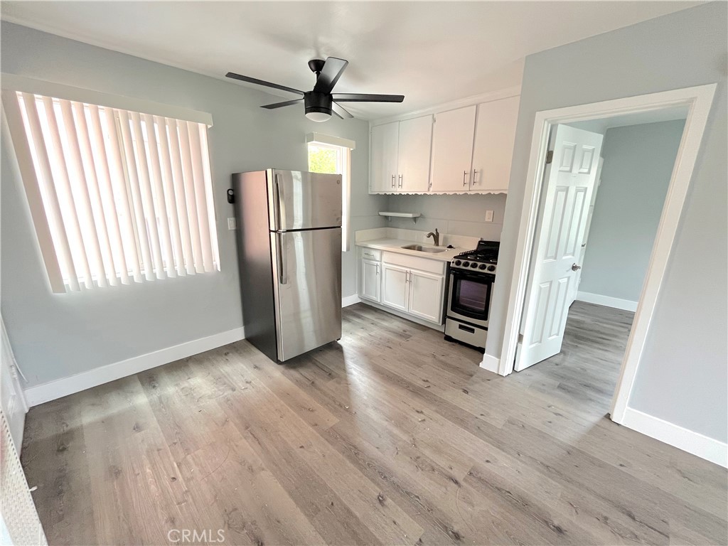 2403 Louella Avenue, Unit 3 Venice, CA 90291 - Photo 4 of 15 a kitchen with stainless steel appliances a refrigerator a stove a sink and a window
