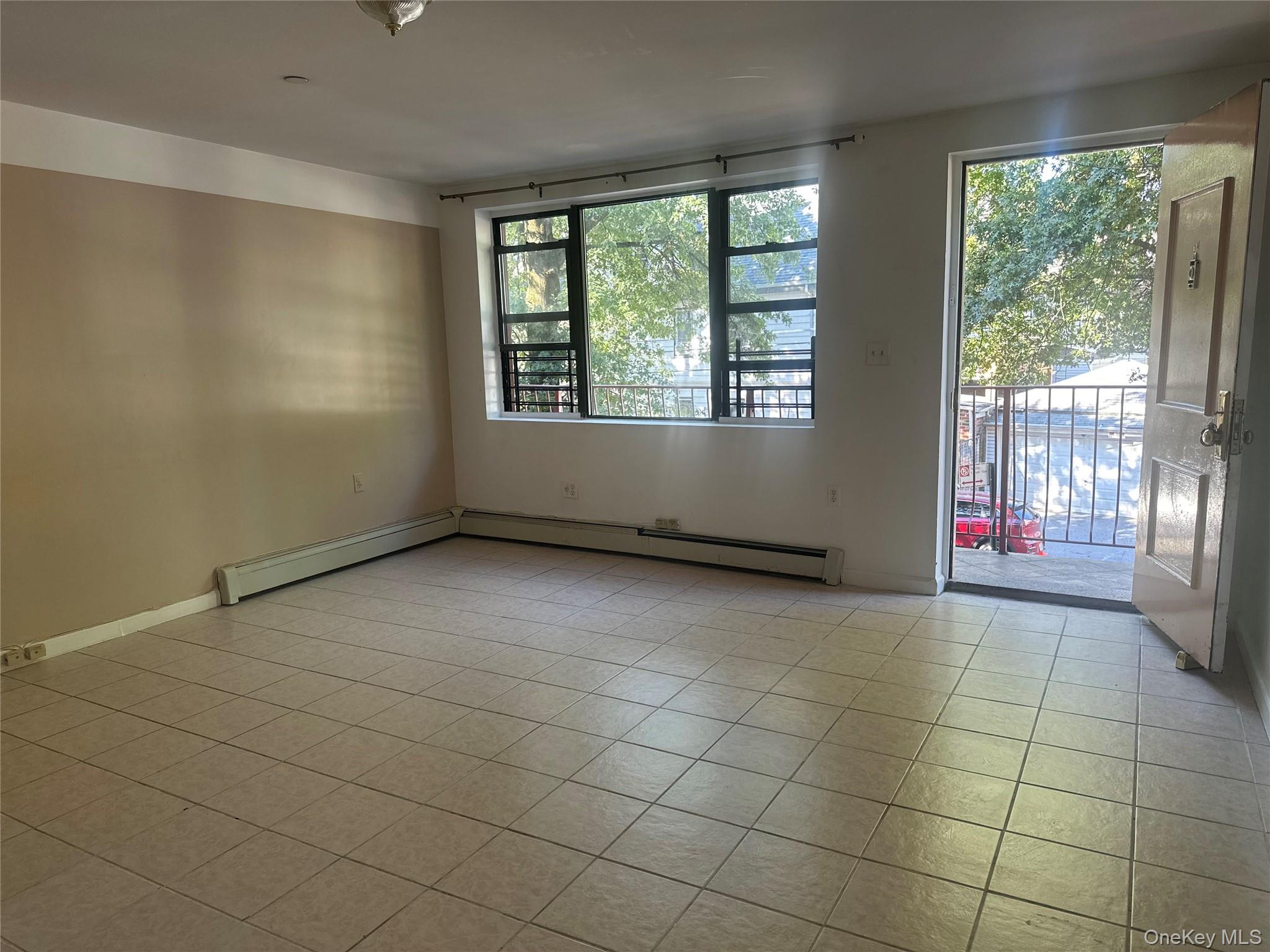40-35 95th Street, Unit 2A Queens, NY 11373 - Photo 2 of 11 a view of an empty room with a window