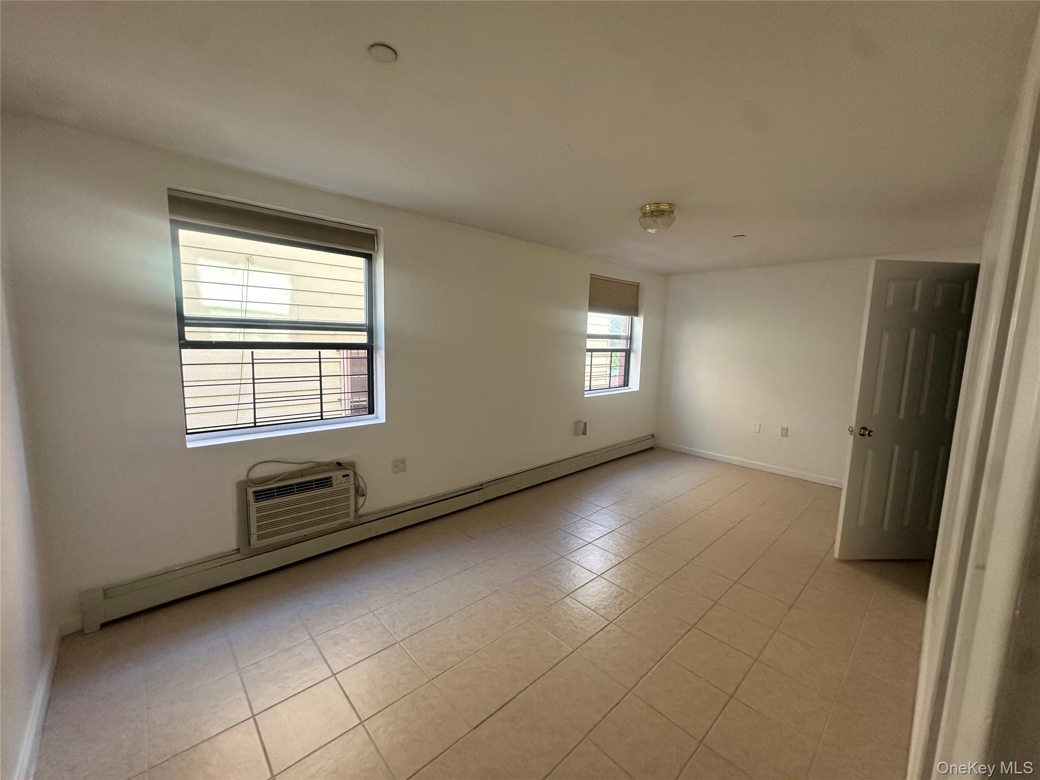 40-35 95th Street, Unit 2A Queens, NY 11373 - Photo 6 of 11 a view of an empty room with a window