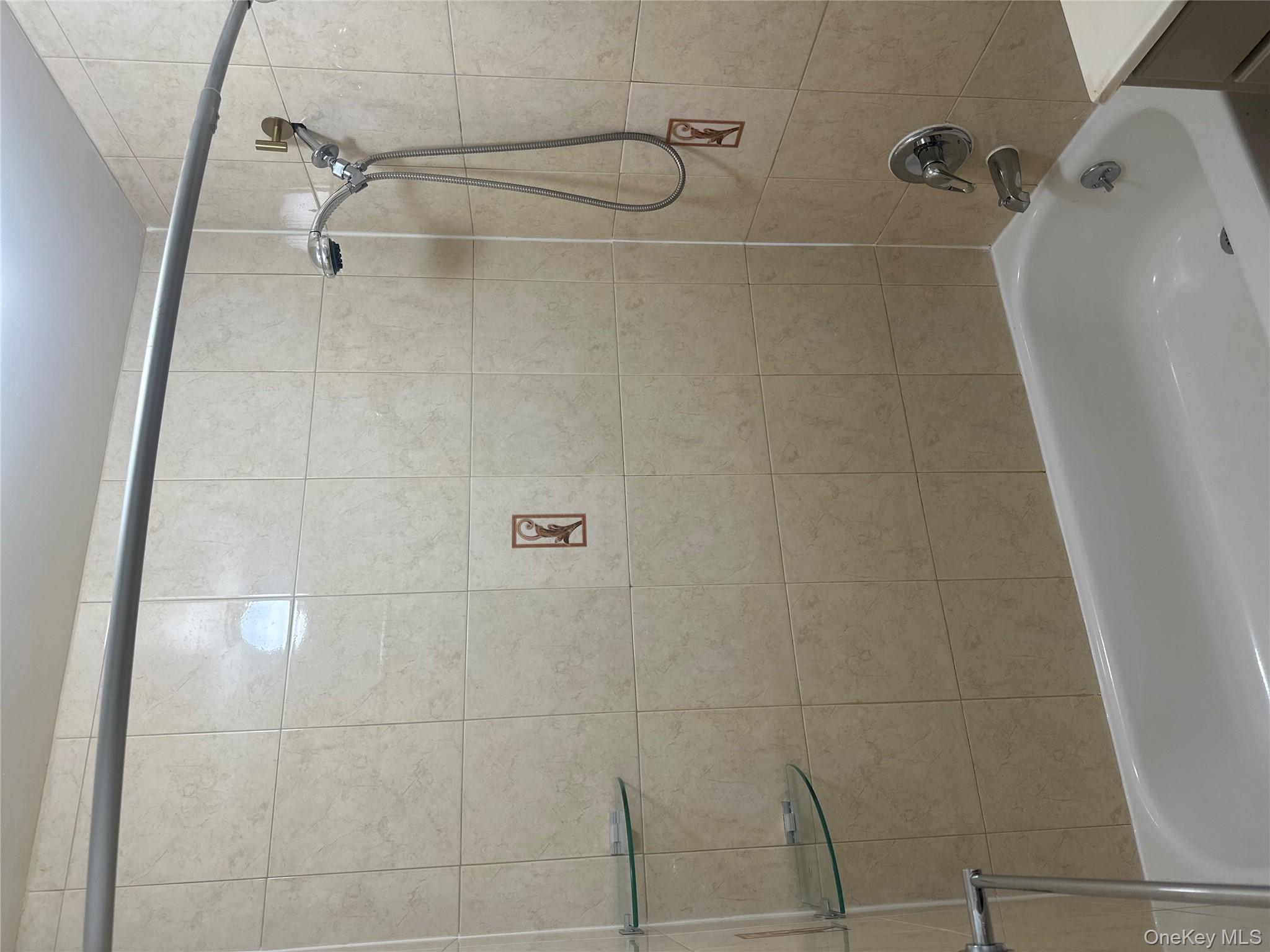 40-35 95th Street, Unit 2A Queens, NY 11373 - Photo 7 of 11 a bathroom with a shower and a bath tub