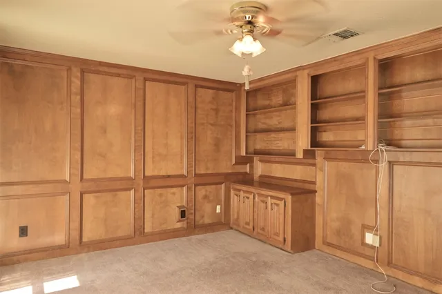 an empty room with a ceiling fan