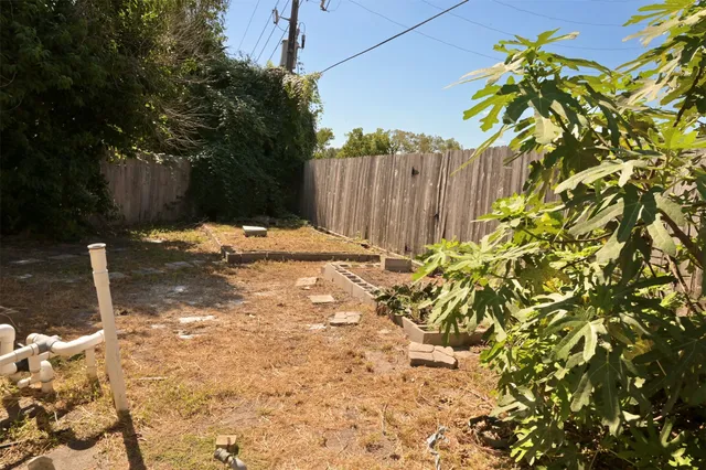 a backyard of a house with a tree