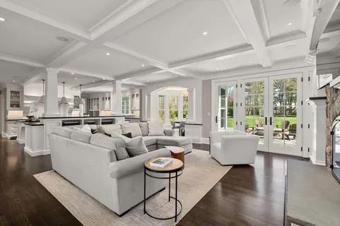 a living room with fireplace furniture and a large window