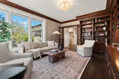 a living room with furniture and a floor to ceiling window