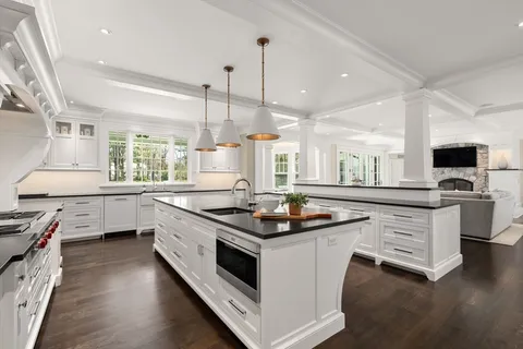 a kitchen that has a sink a stove and chairs