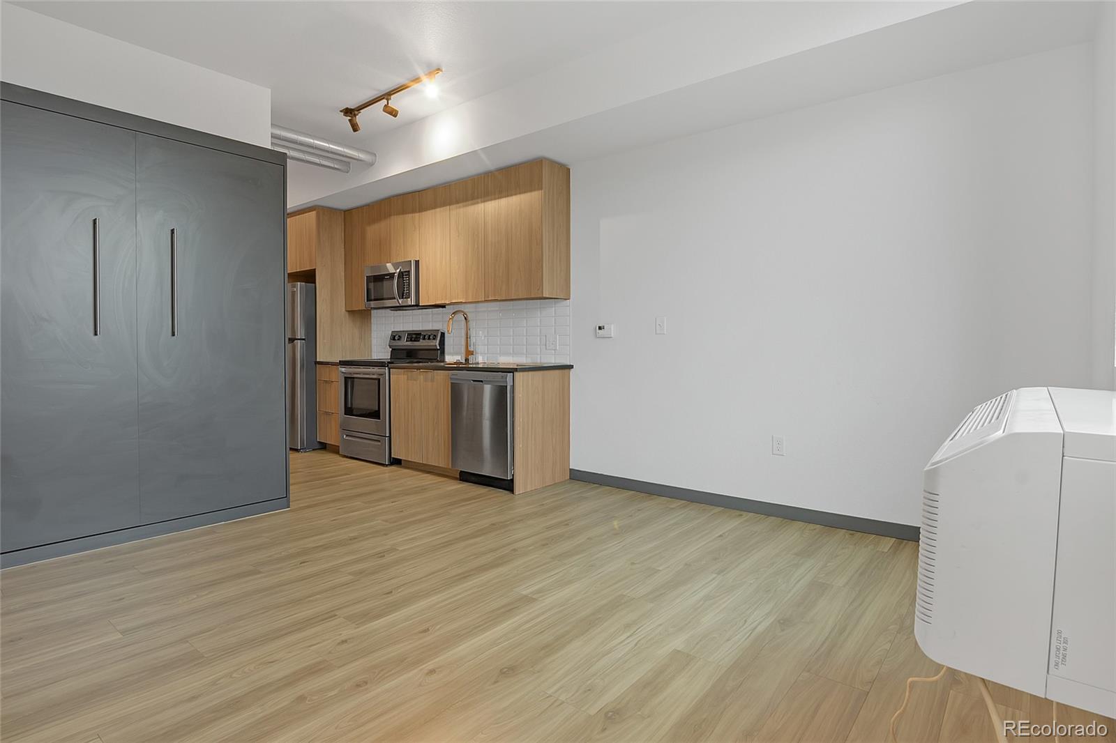 603 Inca Street, Unit 303 Denver, CO 80204 - Photo 10 of 15 a view of a kitchen with wooden floor