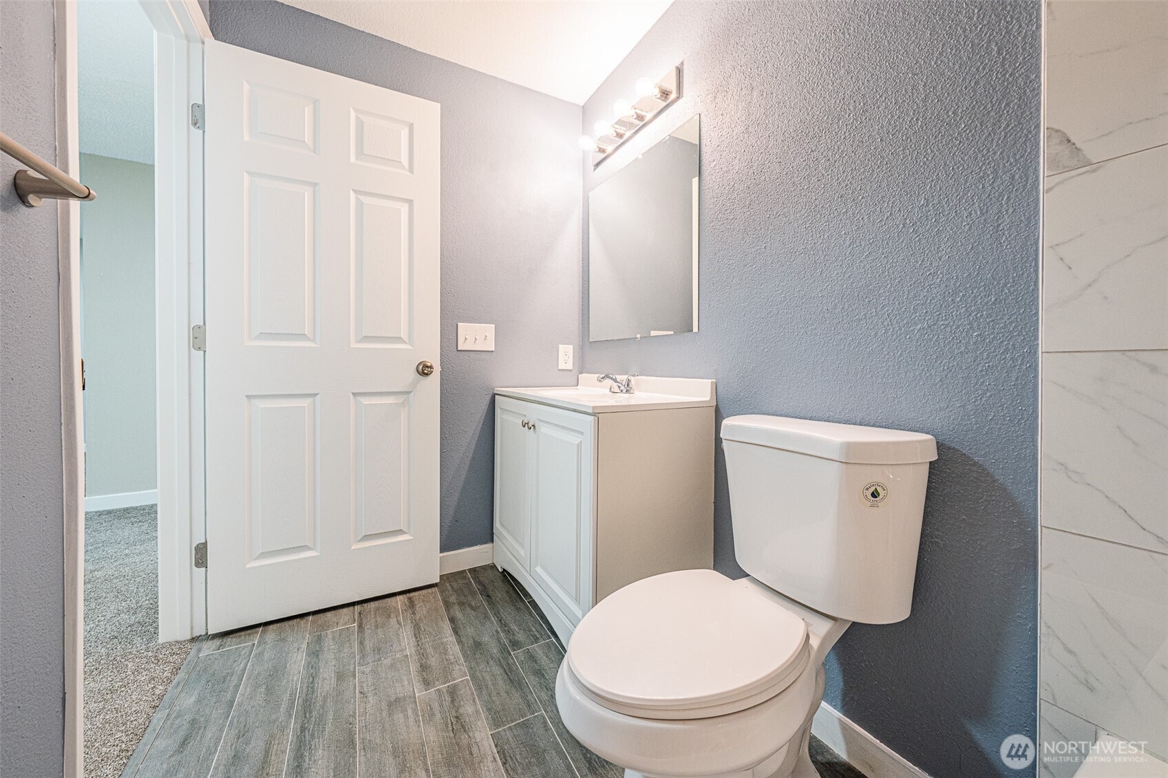 3302 I Street Northeast, Unit B103 Auburn, WA 98002 - Photo 15 of 23 a white toilet sitting next to a bathroom sink